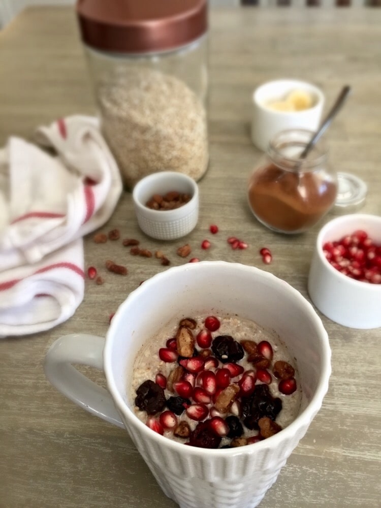 Rustic oatmeal with pomegranate, honey-roasted pecans, dried berries, almond milk